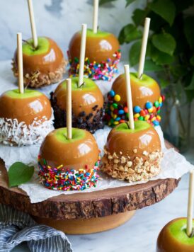 Caramel apples on a wooden cake stand