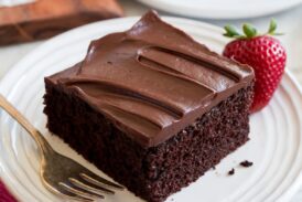 Slice of easy to make chocolate cake covered with a chocolate ganache frosting.