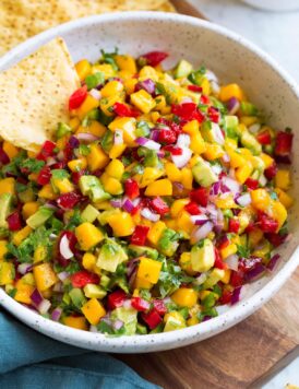 Bowl of mango salsa with a side of tortilla chips.