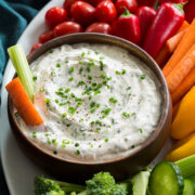 Close up photo of ranch dip in a wooden bowl.