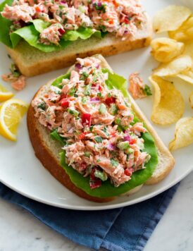 Salmon salad shown on a slice of bread.