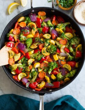 Photo: Sautéed Vegetables shown from above in a black skillet sitting on a marble tabletop.