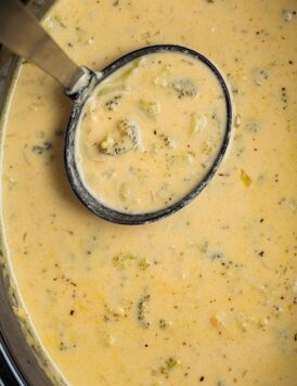 An overhead shot of a slow cooker broccoli cheese soup