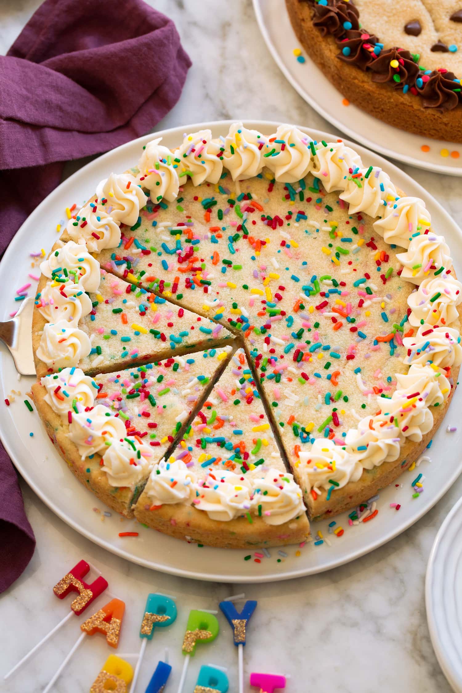 Whole sugar cookie cake with frosting on edges.